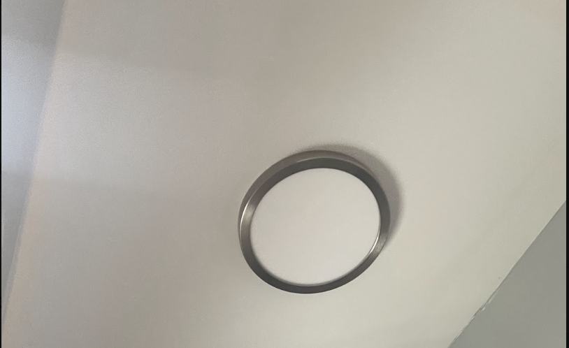 Flush-mount ceiling light fixture installed on a white ceiling