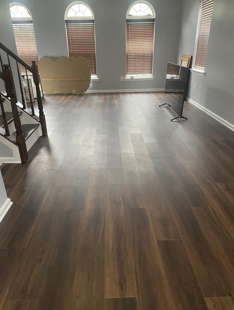 Living room with new wood-look flooring, grey walls and white trim